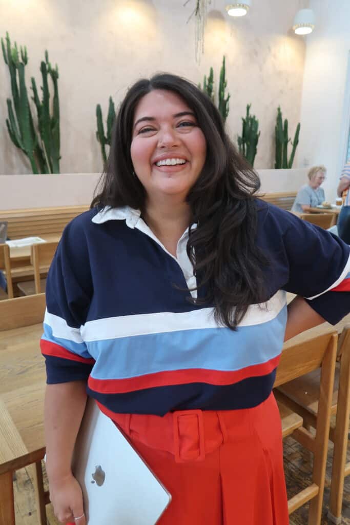 Smiling woman in a striped jacket posing for a portrait